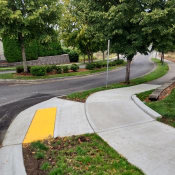 "Curb ramp in landscaped neighborhood"